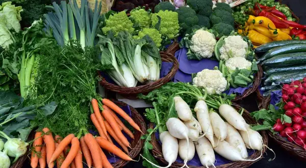 Un étalage coloré de légumes frais : carottes, radis, choux-fleurs, poireaux, courgettes, brocolis et poivrons. Un vrai festin de fruit et légume en t!