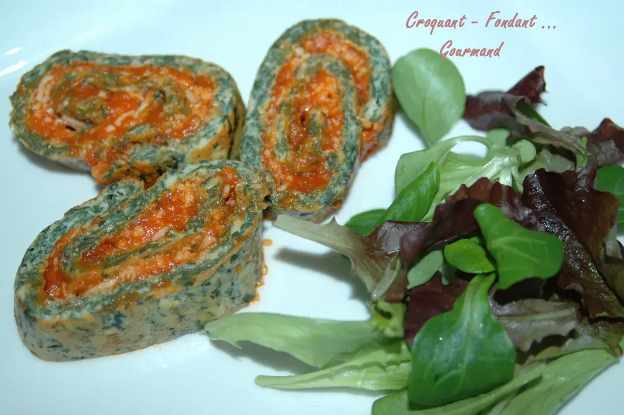 Rouleaux de blette farcis à la sauce tomate, servis avec une salade verte.